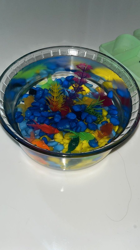 Close-up of the test tank's coloured gravel and plastic plants
